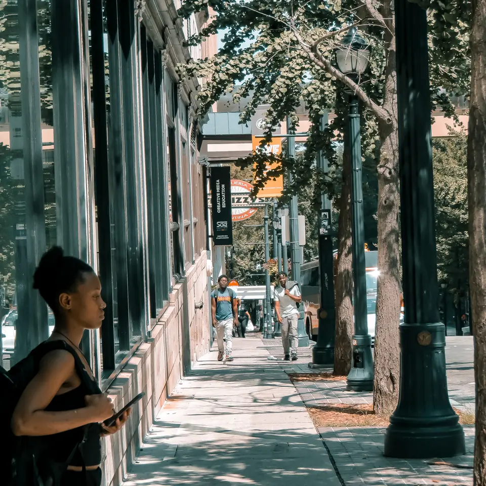 A long sidewalk perspective under a colonnade in downtown Atlanta